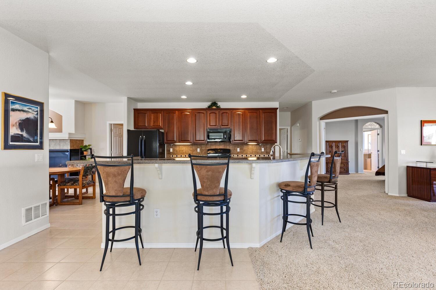 8322 South Quatar Circle Aurora, CO 80016 - Photo 9 of 47 a view of kitchen with stainless steel appliances granite countertop dining table chair and microwave