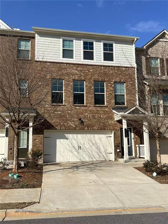 a front view of a house with a road