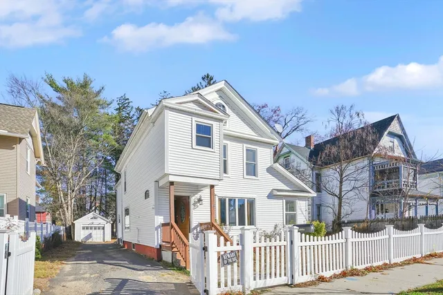 a front view of a house with a iron gate