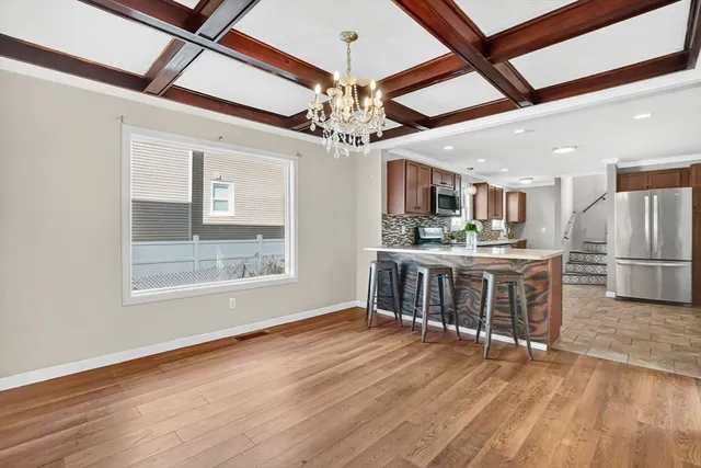 a open kitchen with stainless steel appliances granite countertop a stove and a refrigerator