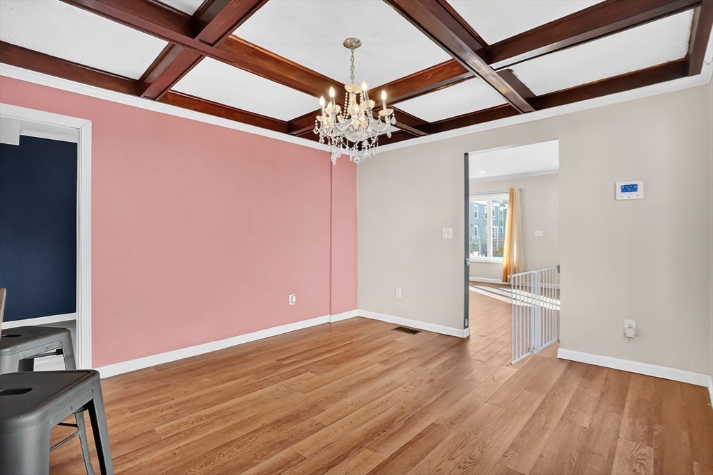 41 Florida Street Springfield, MA 01109 - Photo 12 of 41 a view of an empty room with wooden floor and a ceiling fan