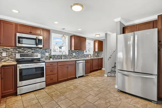 a kitchen with stainless steel appliances granite countertop a refrigerator sink and microwave