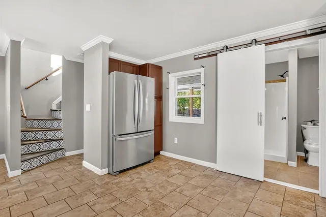 a view of a storage & utility room with closet dryer