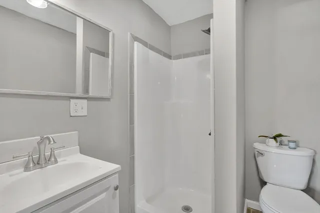 a bathroom with a sink toilet and a mirror