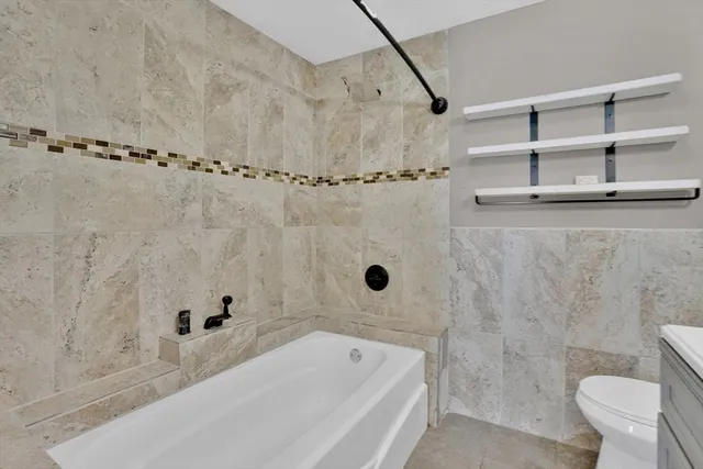 a bathroom with a bathtub and shower