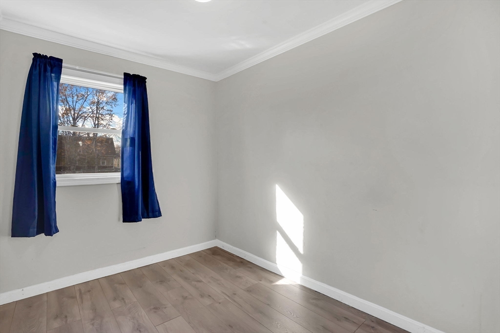 41 Florida Street Springfield, MA 01109 - Photo 28 of 41 an empty room with wooden floor and windows