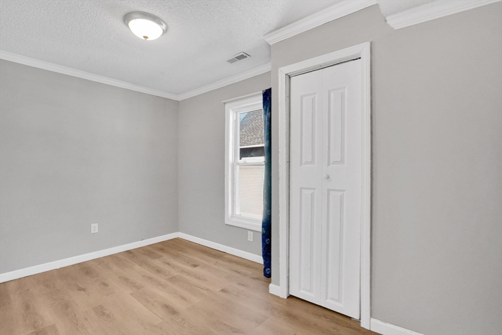 41 Florida Street Springfield, MA 01109 - Photo 34 of 41 an empty room with wooden floor and closet