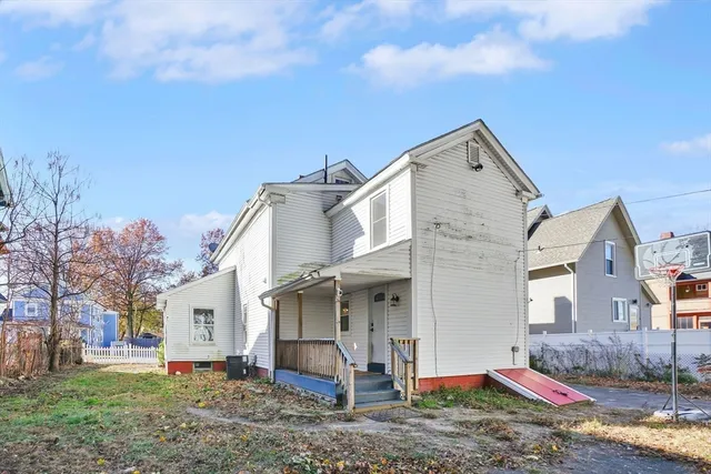 a view of a house with a yard and tree s