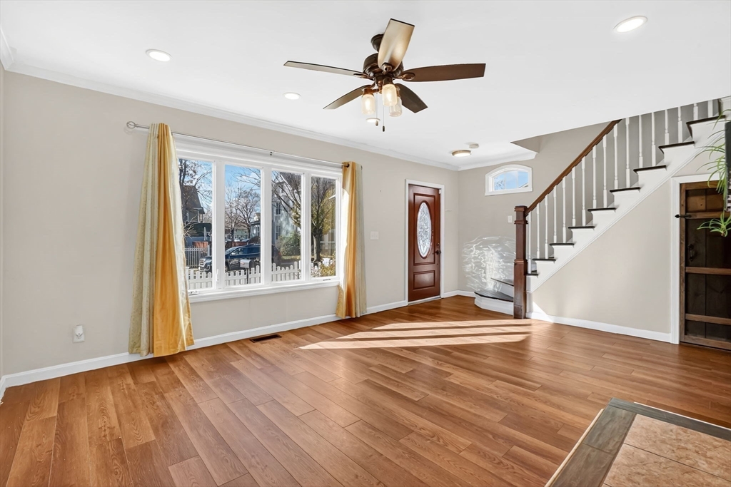 41 Florida Street Springfield, MA 01109 - Photo 5 of 41 a view of an empty room with wooden floor and a window
