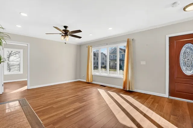 a view of a room with a ceiling fan and window