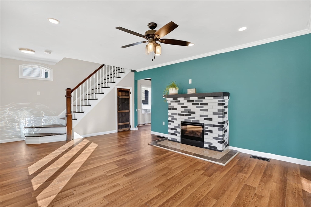 41 Florida Street Springfield, MA 01109 - Photo 7 of 41 a view of a livingroom with wooden floor a ceiling fan and staircase