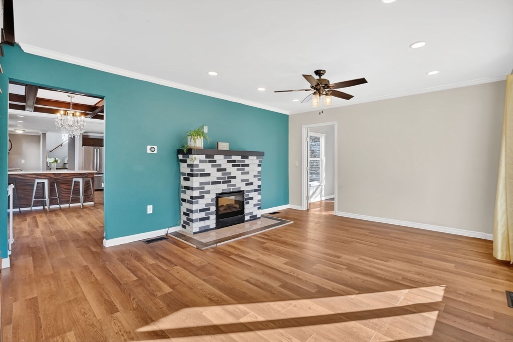 41 Florida Street Springfield, MA 01109 - Photo 8 of 41 a view of a livingroom with a fireplace a chandelier and wooden floor