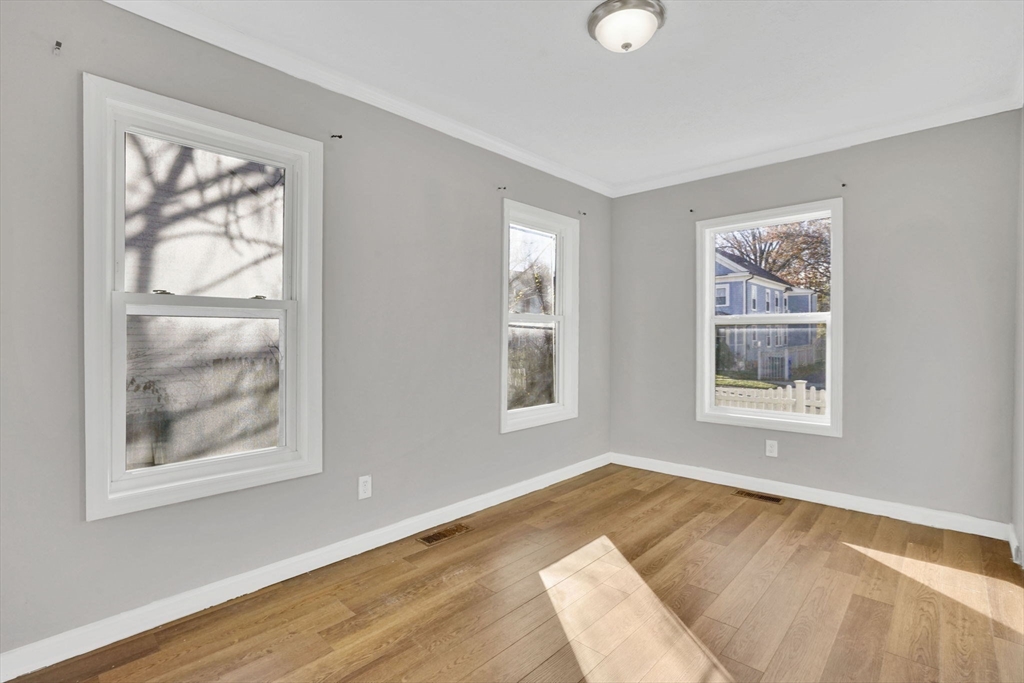 41 Florida Street Springfield, MA 01109 - Photo 10 of 41 a view of an empty room with wooden floor and a window