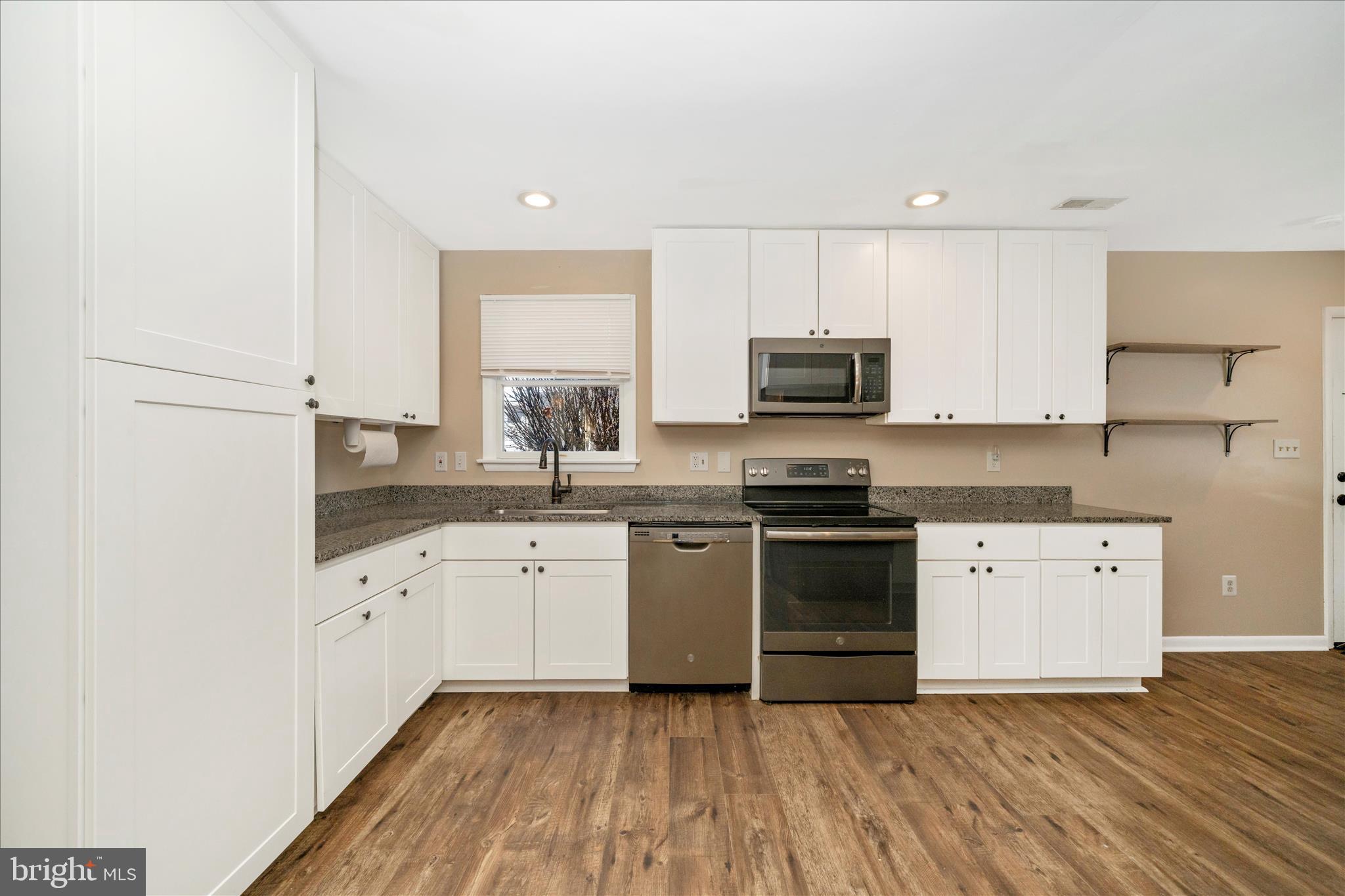 923 Klees Mill Road Westminster, MD 21157 - Photo 14 of 52 a kitchen with granite countertop a sink and a stove top oven