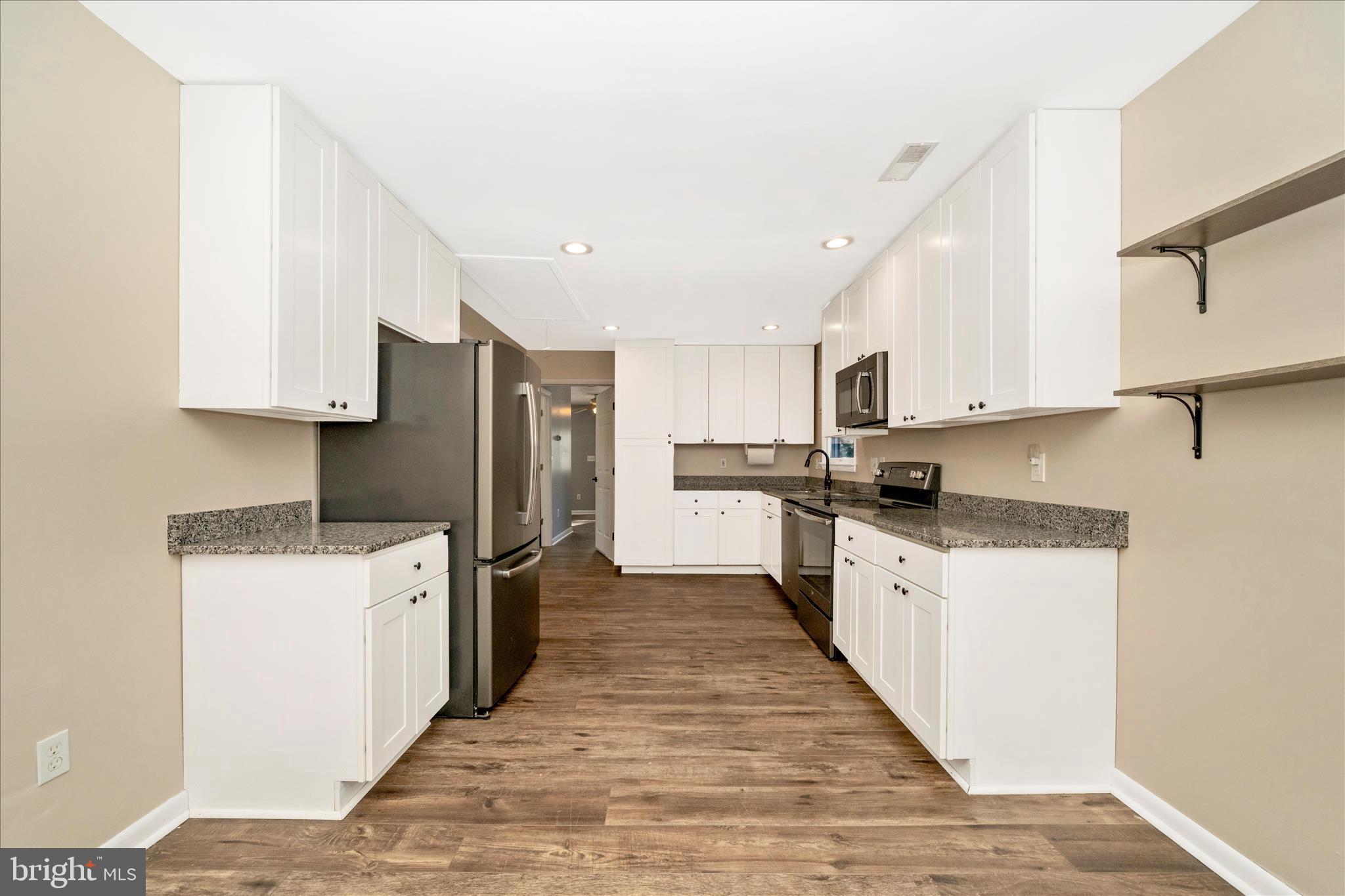 923 Klees Mill Road Westminster, MD 21157 - Photo 16 of 52 a kitchen with a sink a stove top oven and white stainless steel appliances