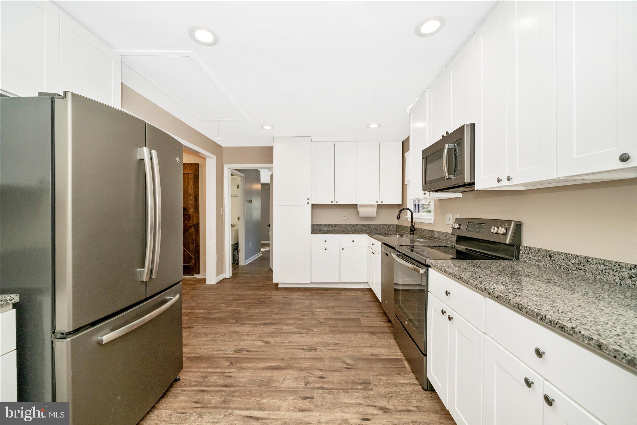 923 Klees Mill Road Westminster, MD 21157 - Photo 17 of 52 a large kitchen with stainless steel appliances granite countertop a refrigerator and a stove top oven