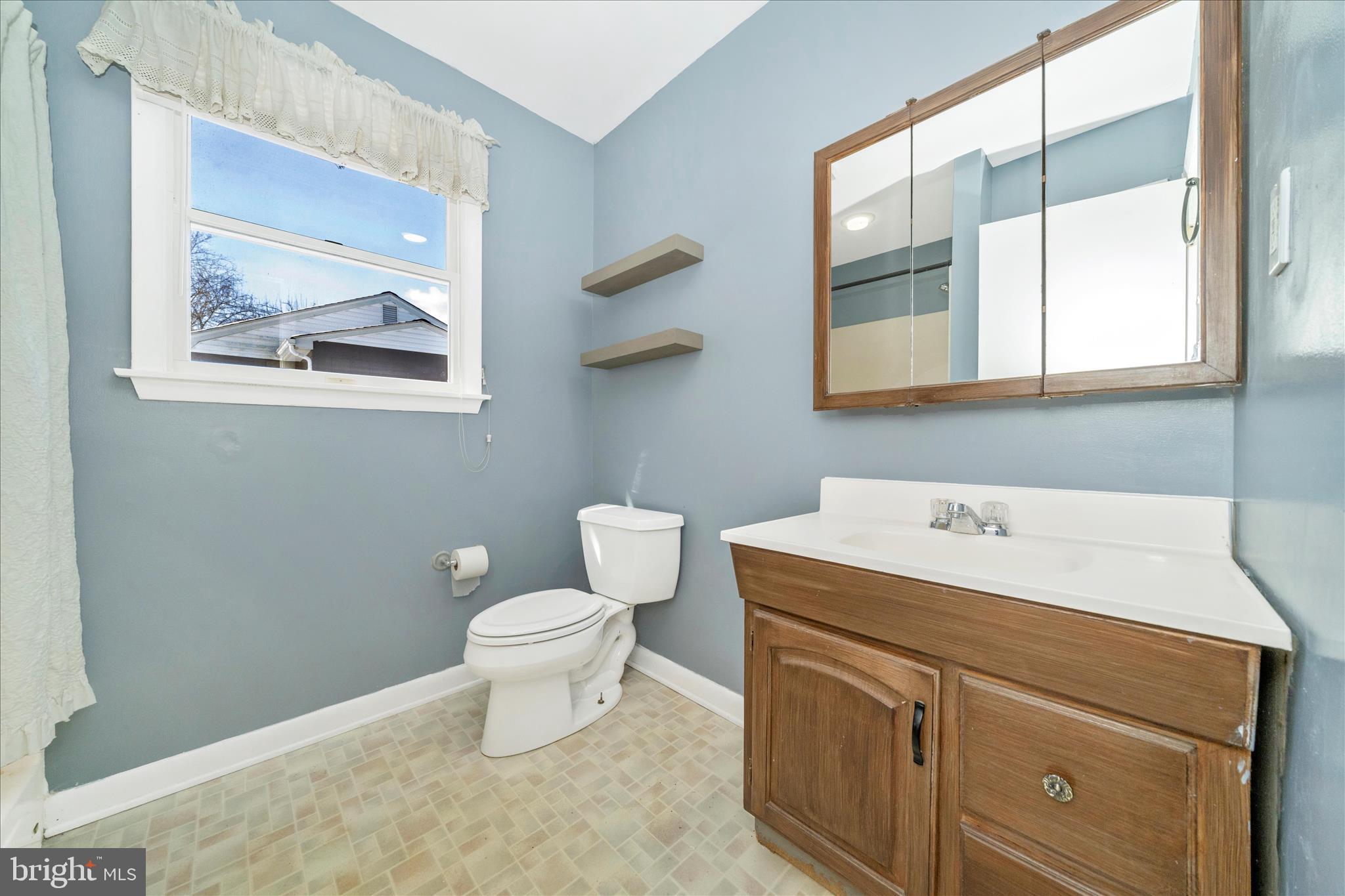 923 Klees Mill Road Westminster, MD 21157 - Photo 37 of 52 a bathroom with a toilet sink and mirror