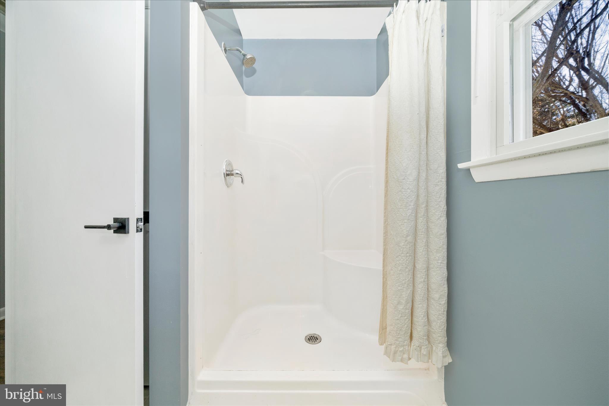 923 Klees Mill Road Westminster, MD 21157 - Photo 38 of 52 a bathroom with a glass shower door