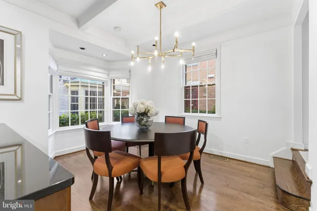 a view of a dining room with furniture and chandelier