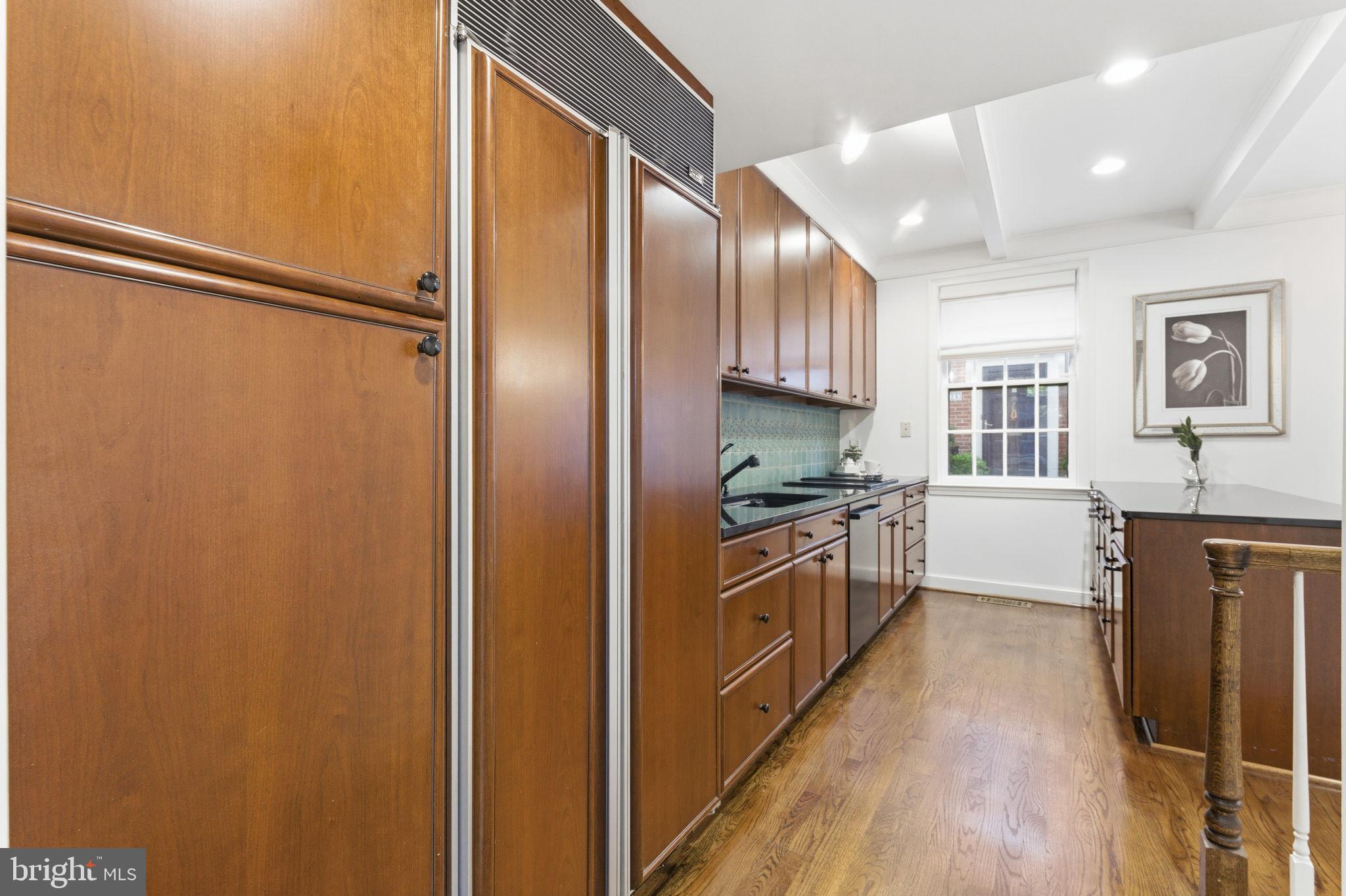 4354 Westover Place Northwest Washington, DC 20016 - Photo 18 of 63 a kitchen with stainless steel appliances a refrigerator a sink a stove a microwave a center island and cabinets