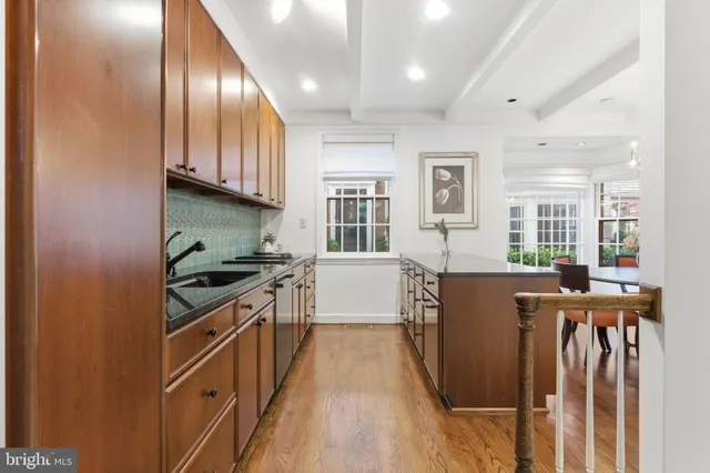 a kitchen with stainless steel appliances granite countertop a sink a counter space and cabinets