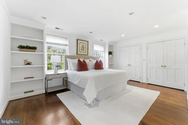 a spacious bedroom with a bed and a view of bathroom