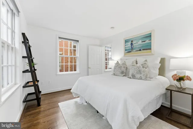 a spacious bedroom with a bed and glass window