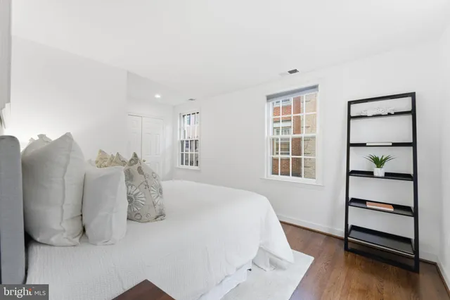 a spacious bedroom with a bed and a large window