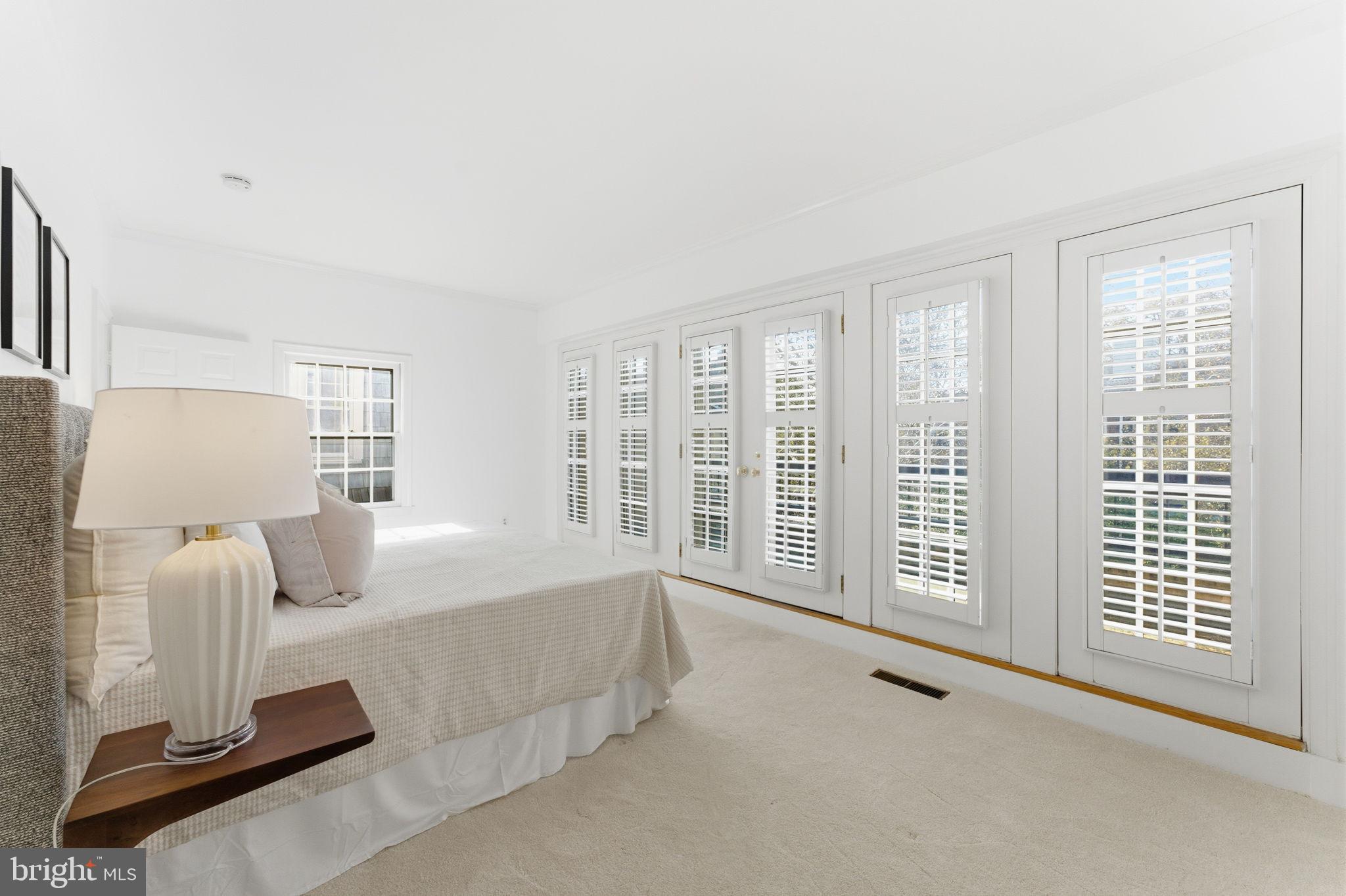 4354 Westover Place Northwest Washington, DC 20016 - Photo 40 of 63 a spacious bedroom with a bed and glass window