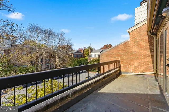 a living room with furniture and kitchen view with wooden floor
