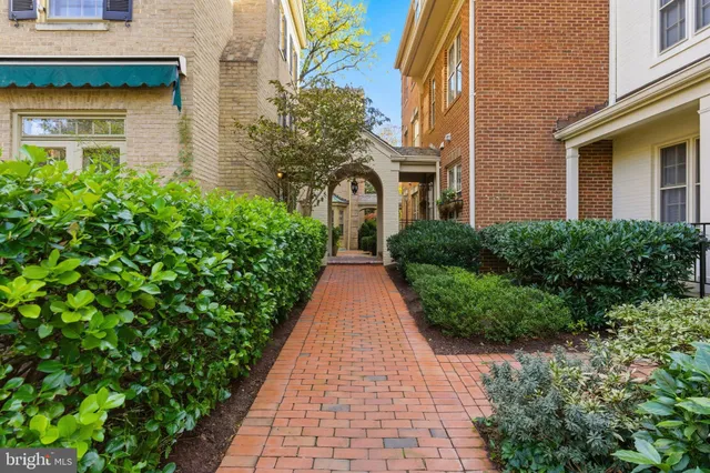 a living room with furniture a fireplace and a large window