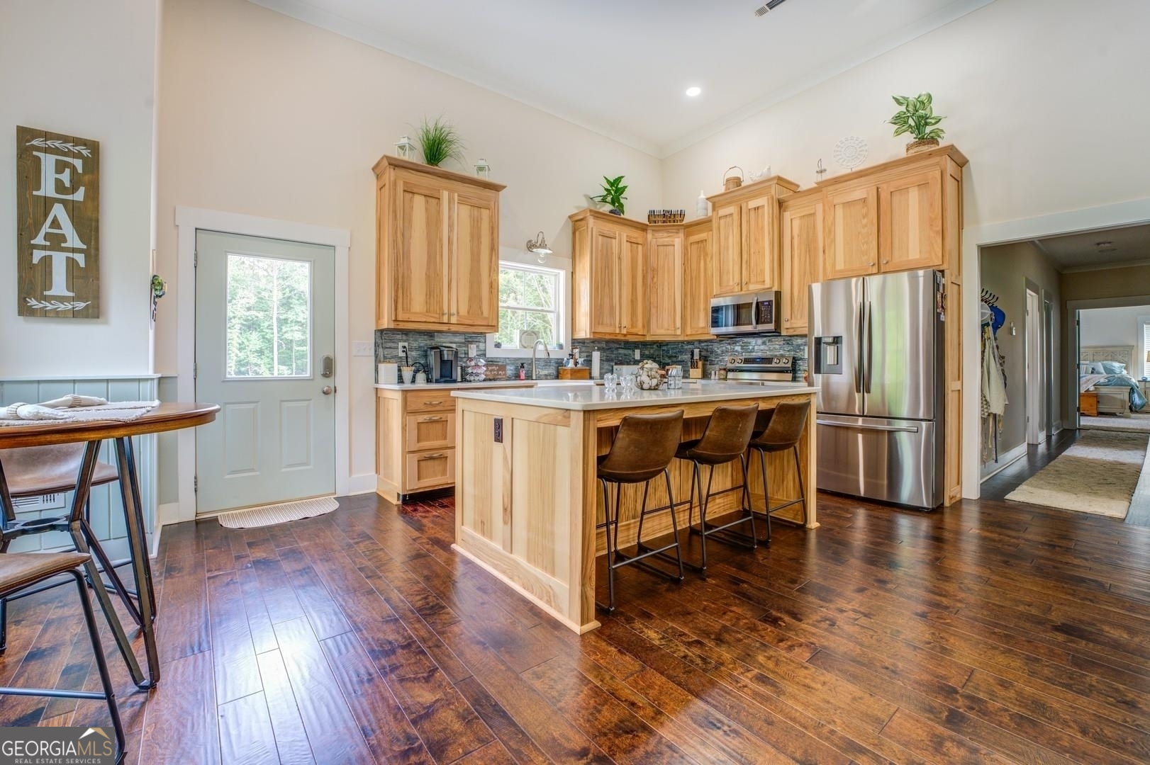 3060 Eatonton Road Madison, GA 30650 - Photo 10 of 65 a kitchen with stainless steel appliances a stove a sink dishwasher and a refrigerator with wooden floor