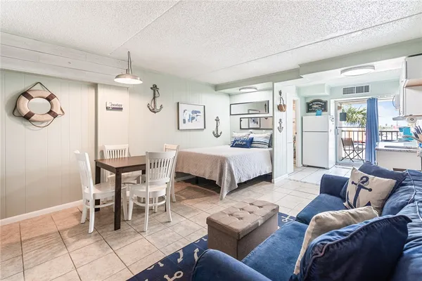 a bedroom with furniture and a large window