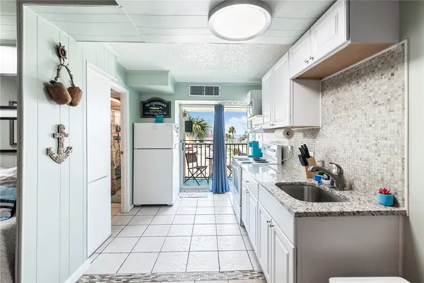 a kitchen with stainless steel appliances a refrigerator and a stove