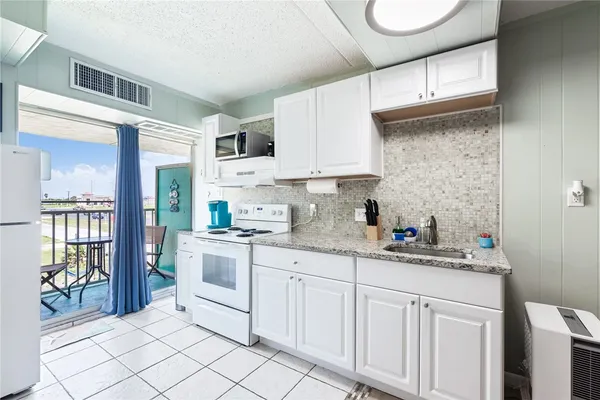 a kitchen with stainless steel appliances granite countertop a sink and cabinets