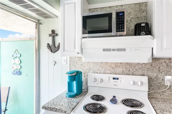 a kitchen with a microwave and a stove