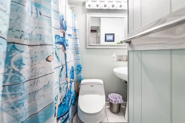 a white toilet sitting next to a bathroom sink
