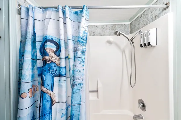 a bathroom with a shower and a shower curtain