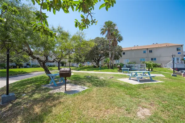 a swimming pool with outdoor seating and yard