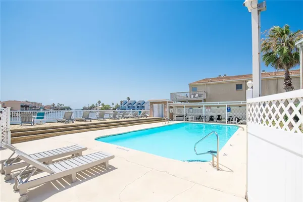 a view of a swimming pool and lounge chair