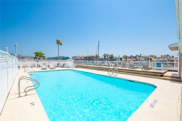 a view of a house with pool and sitting area