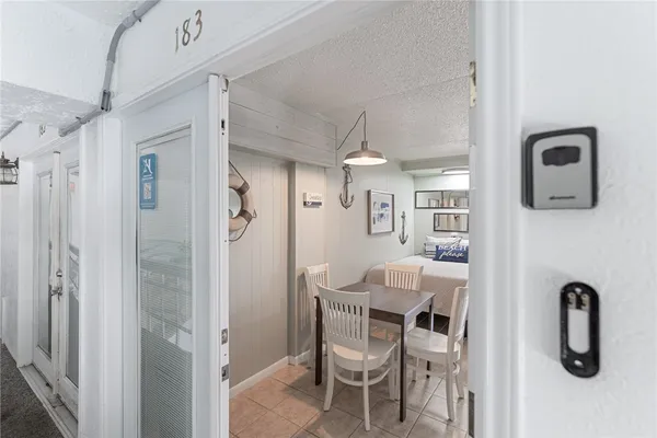 a glass room with table and chairs