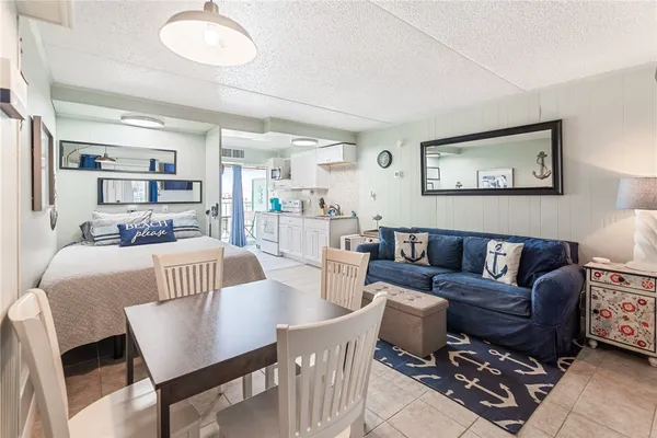 a living room with furniture and a dining table