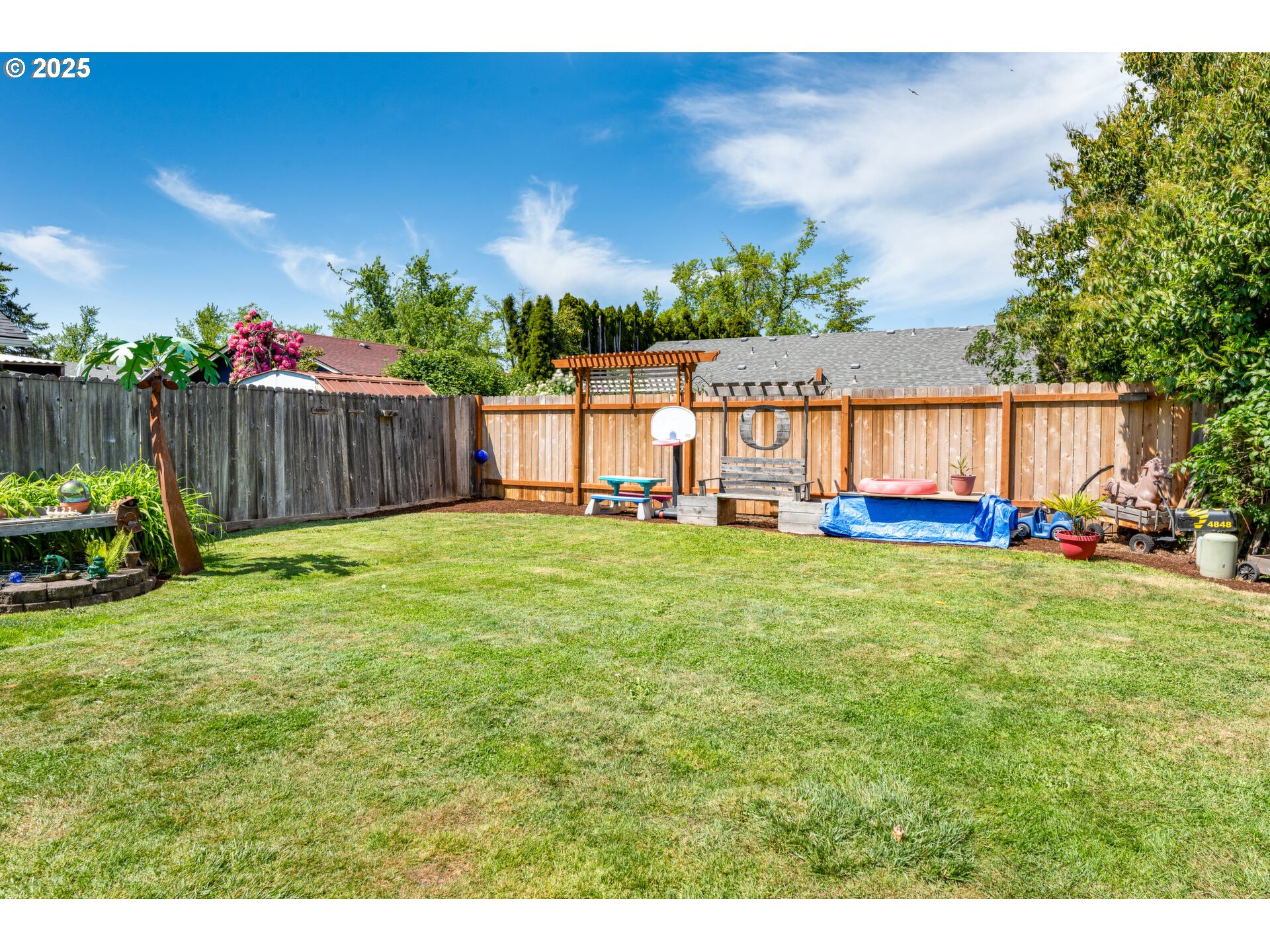 4848 Daisy Street Springfield, OR 97478 - Photo 27 of 36 a view of a backyard with a garden and deck