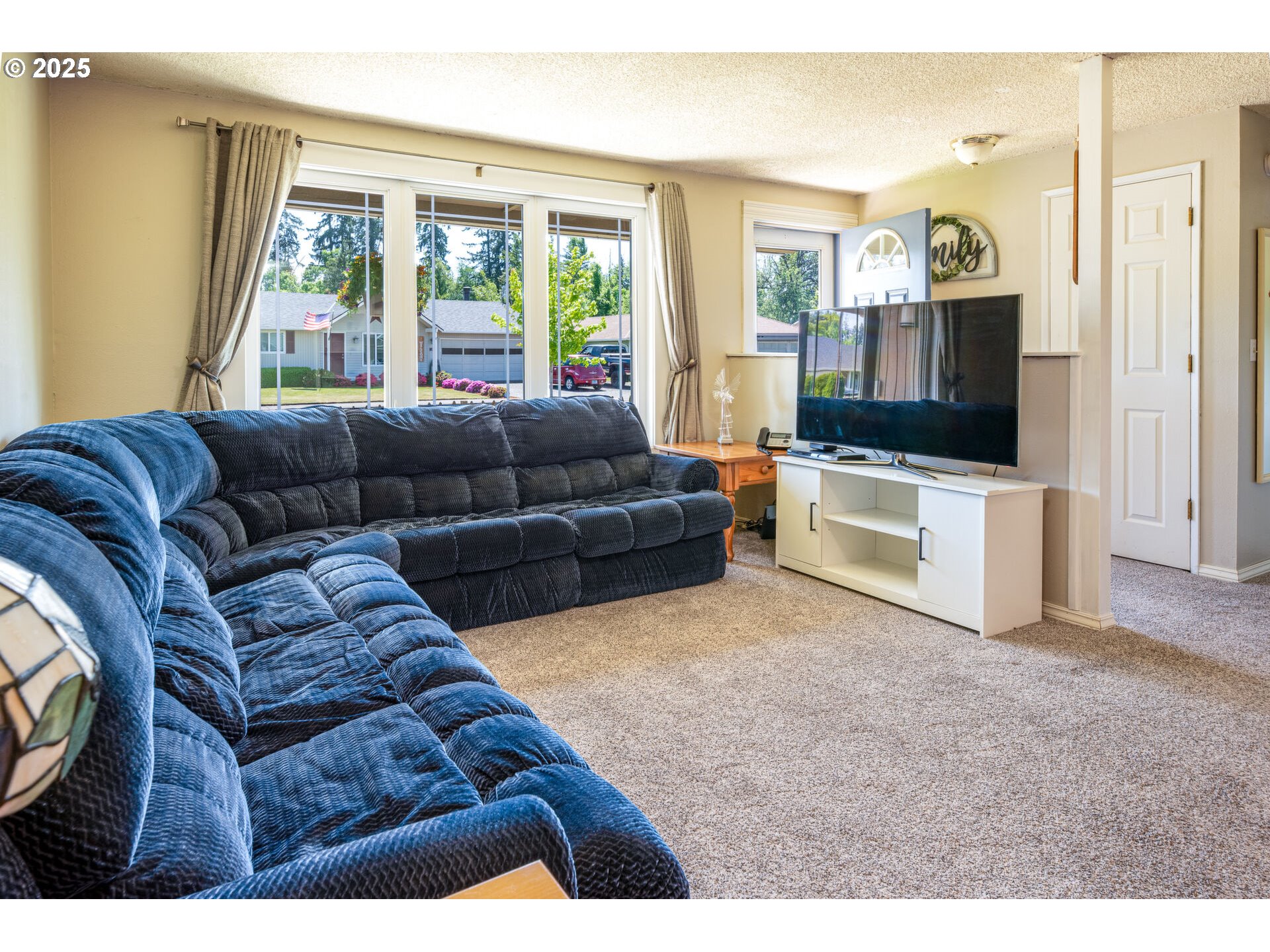 4848 Daisy Street Springfield, OR 97478 - Photo 8 of 36 a living room with furniture and a flat screen tv