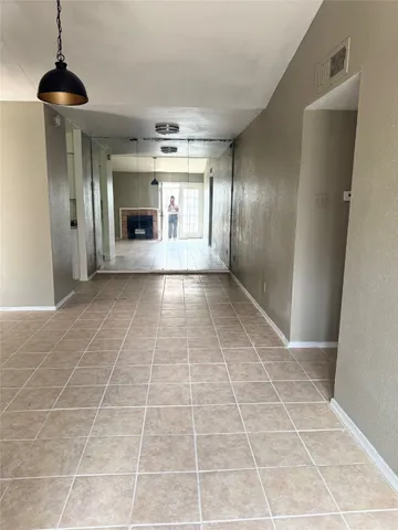 a view of empty room with a fireplace