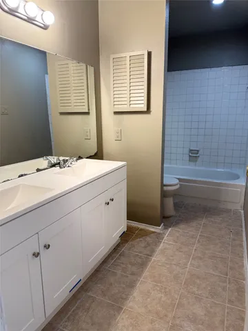 a bathroom with a sink a toilet and bathtub