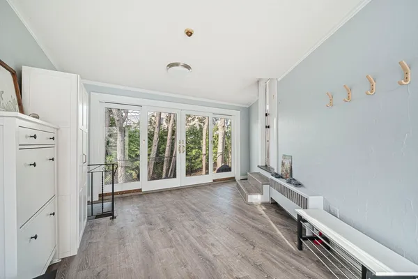 wooden floor in an empty room with a window