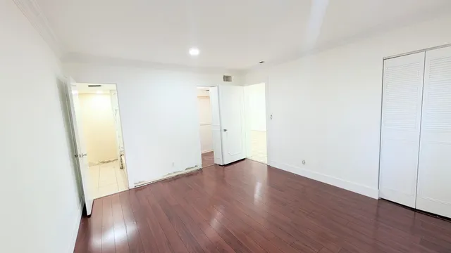 an empty room with wooden floor