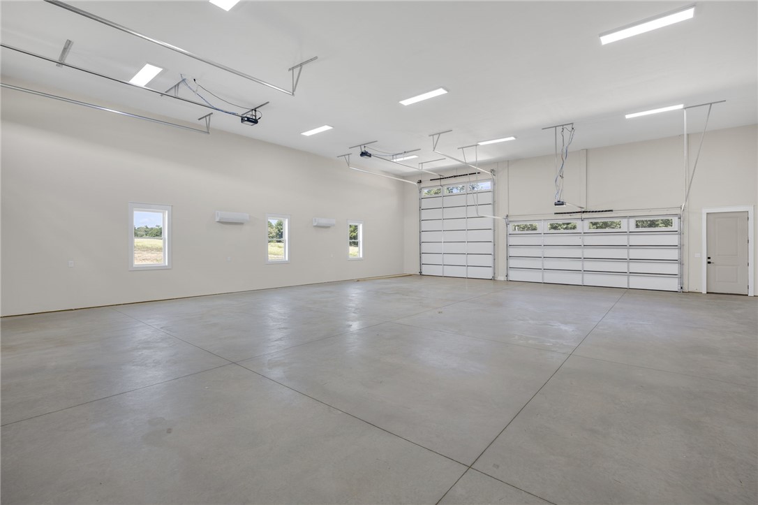384 Jim Smith Road Pendleton, SC 29670 - Photo 35 of 48 Polished concrete floors and overhead lighting define this expansive, multi-car utility space.